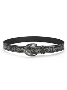 Detail van zwarte leren riem met zilveren patronen en een fonkelende gesp met strass