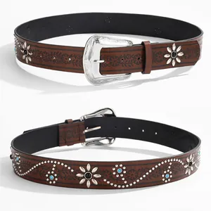 Detail of dark brown leather belt with black floral embroidery and silver floral rivets