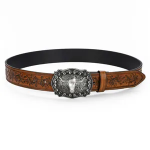Detail of vintage brown leather belt with embossed floral patterns and silver longhorn buckle
