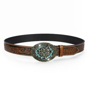 Detail of vintage carved leather belt with turquoise-inset floral metal buckle
