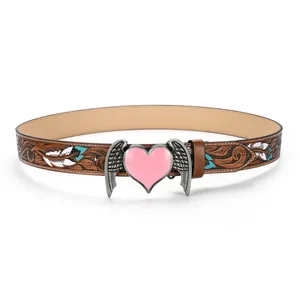 Detail of vintage brown leather belt with bohemian floral carving and pink heart buckle