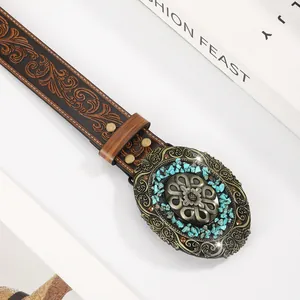 Macro detail of retro leather belt with floral embossing and bronze turquoise buckle