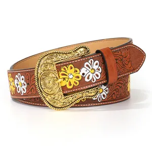 Close-up of embossed floral patterns and hand-painted daisies on a vintage PU leather belt