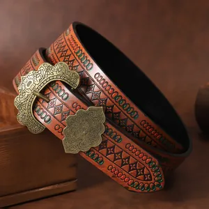 Close-up of vintage Western cowboy belt with embossed leather and floral buckle
