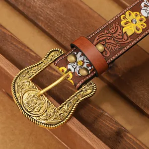Detailed view of vintage brown PU belt featuring colorful floral embossing and metal buckle