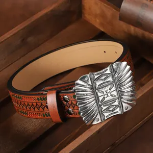 Detail of western cowboy belt with embossed floral pattern and vintage silver buckle
