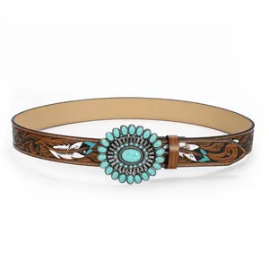 Detailed view of western leather belt featuring floral embossing and turquoise buckle