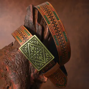 Macro view of vintage Western leather belt featuring embossed geometric patterns and bronze buckle