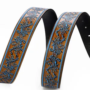 Detail of brown faux wood grain belt with vintage vine floral relief and blue edges