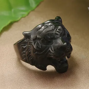 Macro detail of male punk tiger head ring on golden silk fabric background