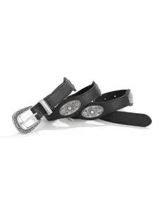 Close-up of vintage western black leather belt with silver floral concho and skull buckle