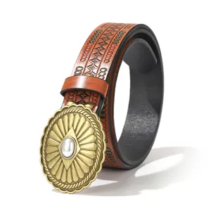 Close-up of vintage Western cowboy belt with embossed leather and brass buckle with pearl