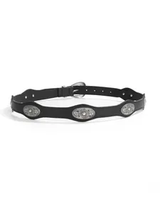 Detail of black leather belt featuring silver floral conchos and scalloped edges