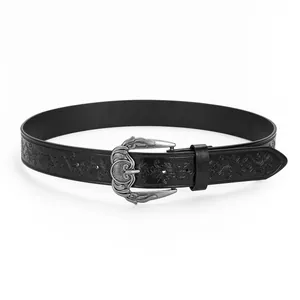 Detailed view of bohemian black leather belt with embossed patterns and silver floral buckle