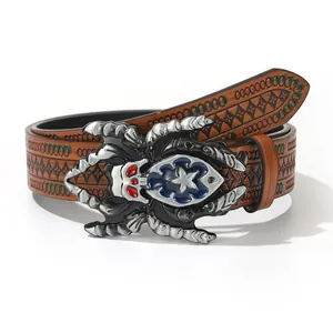 Detail shot of vintage western cowboy belt with embossed pattern and giant metal spider buckle