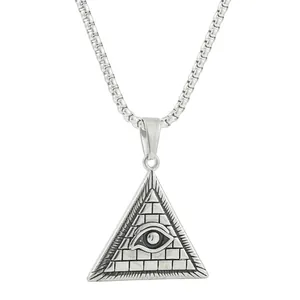 Macro detail of silver pyramid pendant with Eye of Providence and brick texture