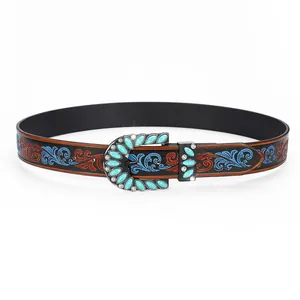 Detailed view of bohemian western belt with turquoise buckle and floral embossed leather