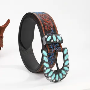 Detail of bohemian leather belt with turquoise buckle and vintage floral carving