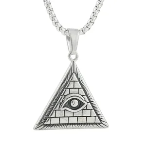 Macro detail of retro stainless steel pyramid pendant with all-seeing eye and sunburst engraving