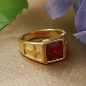 Close-up of vintage gold stainless steel ring with square red stone and cross relief