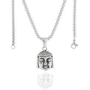 Macro shot of vintage titanium steel Buddha pendant with oxidized details and box chain