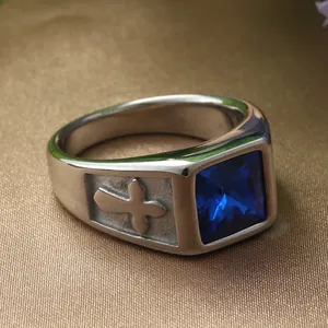 Macro shot of vintage steel ring featuring a blue square stone and cross relief detail