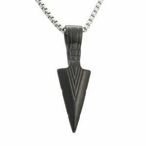 Macro detail of a black spearhead pendant with a silver stainless steel box chain