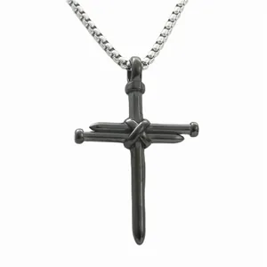 Detailed close-up of punk style cross pendant made of intertwined industrial steel nails