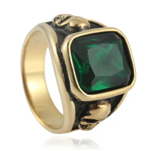 Vintage punk skull ring in gold with a large emerald green gemstone and gothic relief