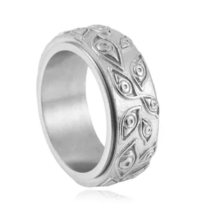 Macro detail of rotatable evil eye engraving on a vintage punk stainless steel ring