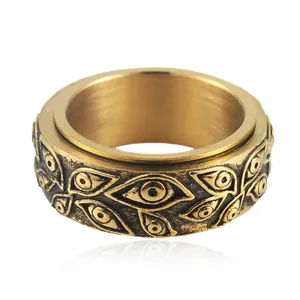 Macro detail of vintage gold rotating ring with embossed evil eye patterns