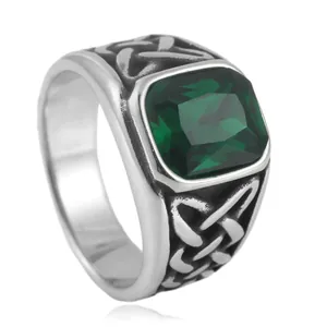 Detailed macro shot of vintage ring with square green stone and Celtic knot patterns