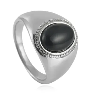 Vintage stainless steel ring with oval black onyx stone and polished finish on white background