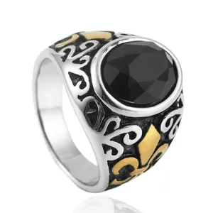 Vintage stainless steel ring with black faceted gemstone and gold fleur-de-lis patterns