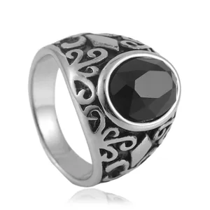 Vintage stainless steel ring with black oval stone and intricate floral hollow engravings