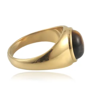 Detail view of gold stainless steel ring featuring a polished oval brown tiger eye stone