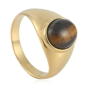 Macro detail of gold-tone signet ring with oval brown tiger eye stone on white background
