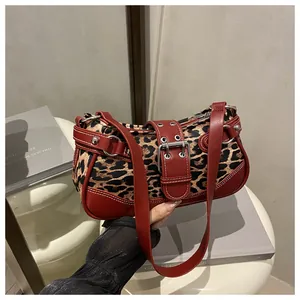 Detail of leopard print fabric texture and red leather trim on vintage shoulder bag