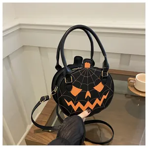 Detailed embroidery of pumpkin face and spider web on black leather Halloween handbag