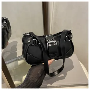 Detail of vintage black crescent underarm bag with silver grommets and belt buckle