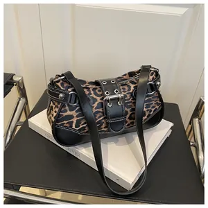 Detail view of leopard print crescent bag with silver studs and metal buckle closure
