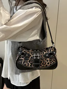 Retro leopard print underarm bag with silver rivet details shown on a fashion model