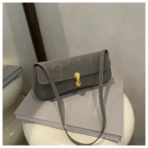 Detailansicht der grauen Handtasche mit Leopardenprägung, Samtoptik und goldenem Verschluss