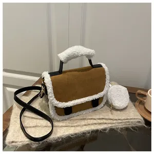 Detail of camel suede handbag with white faux shearling trim and detachable pouch