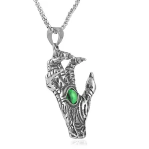 Detailed view of punk style stainless steel demon claw pendant with green gemstone