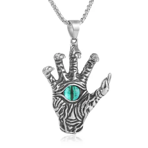 Gothic silver stainless steel demon hand pendant necklace with green evil eye detail