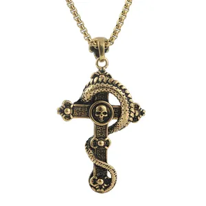 Close-up of gold gothic cross pendant with skull and dragon relief on box chain