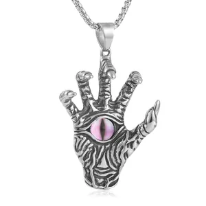 Macro shot of punk style stainless steel hand pendant with a purple eye stone detail