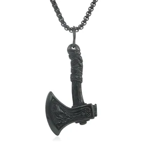 Detailed close-up of a vintage steel battle axe pendant with ornate engraved patterns