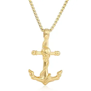 Macro view of gold punk skull and anchor pendant with polished stainless steel finish